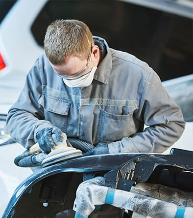 automotive collision technician repairing denter car